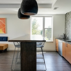 Club Room Kitchenette Contemporary club room kitchen with sleek finishes and open seating.