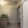 Bathroom with wood-grain vanity, white tiled shower, and gray countertops in a Denver apartment.