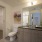 Bathroom in Denver apartments with gray vanity, walk-in closet, and modern finishes.