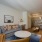 Open apartment layout in Denver with living area, desk, and kitchen.