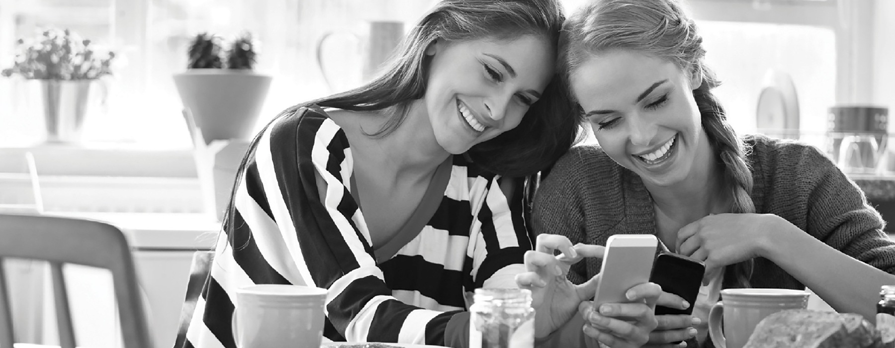 lifestyle image of two women interacting with their phone